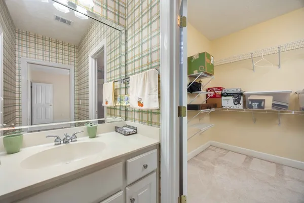 a en suite bathroom with a sink double vanity and a mirror