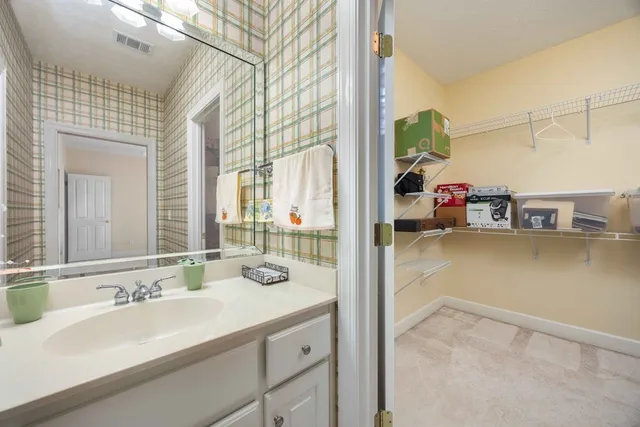 a en suite bathroom with a sink double vanity and a mirror