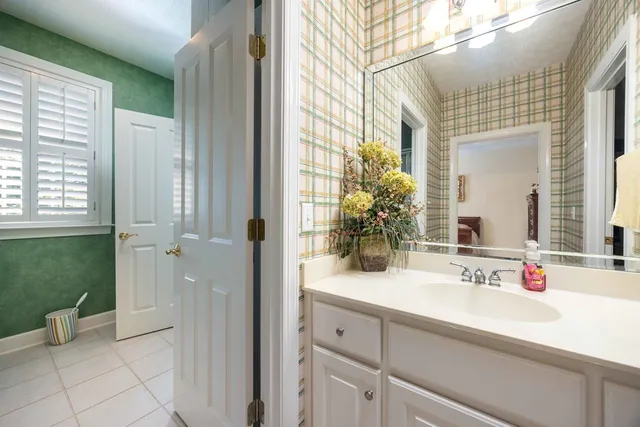 a bathroom with a double vanity sink and mirror with shower