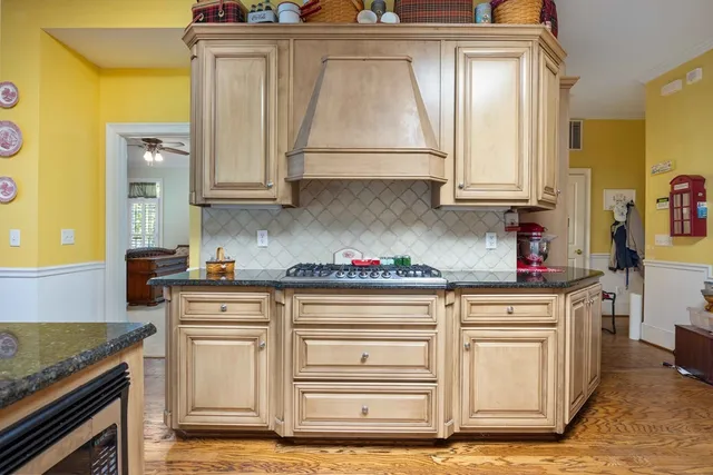 a kitchen with stainless steel appliances granite countertop a refrigerator and a stove top oven
