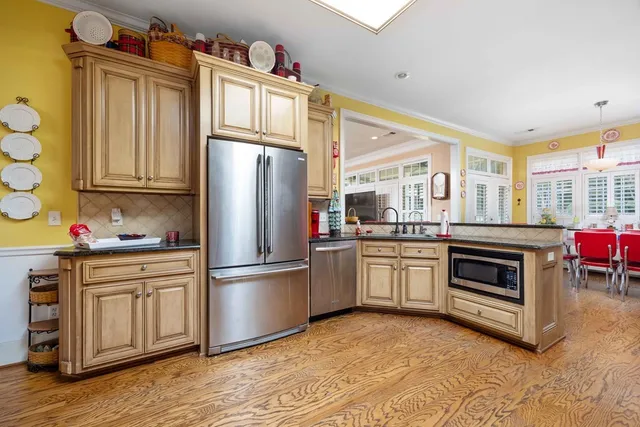 a kitchen with stainless steel appliances a stove a sink and cabinets