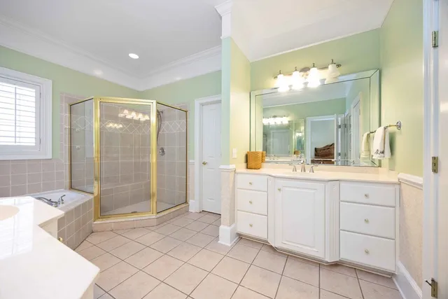 a spacious bathroom with a shower sink mirror and