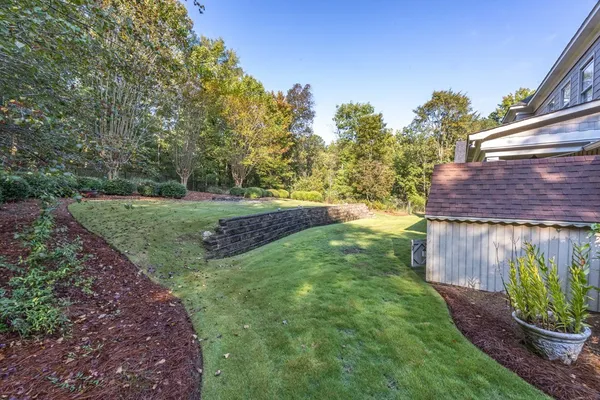 a view of a house with swimming pool and a yard