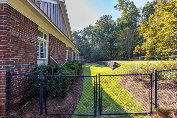 a backyard of a house with table and chairs