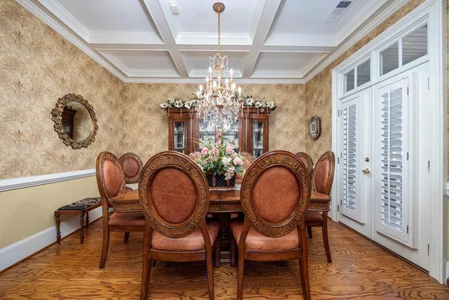 a view of a dining room with furniture and chandelier