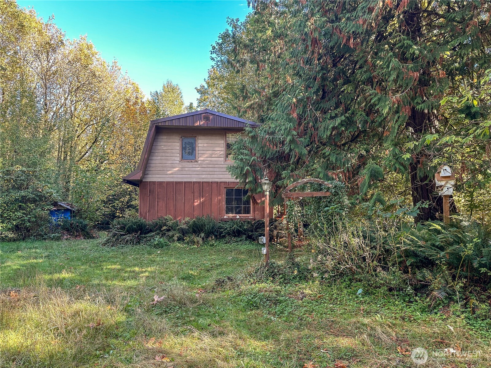 490 West Maple Rock Road Matlock, WA 98560 - Photo 2 of 20 a view of a wooden house with a yard