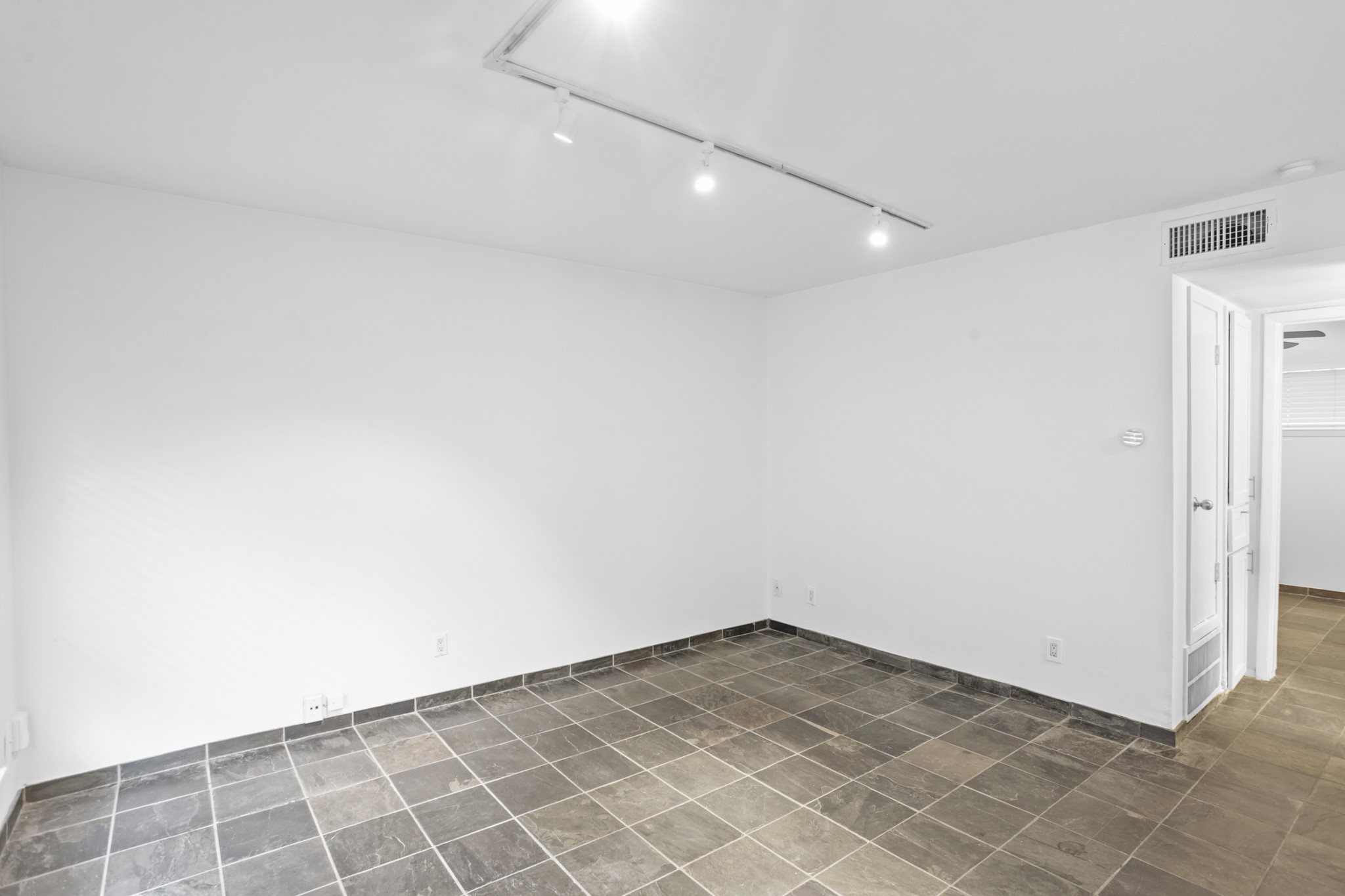 3602 Garrott Street, Unit 11 Houston, TX 77006 - Photo 14 of 34 an empty room with white wall and tiles