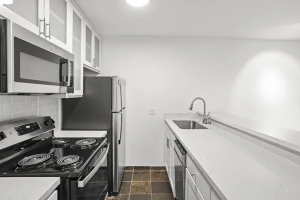 a utility room with sink dryer and washer