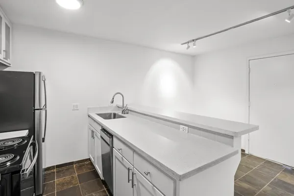 a close view of a sink and refrigerator