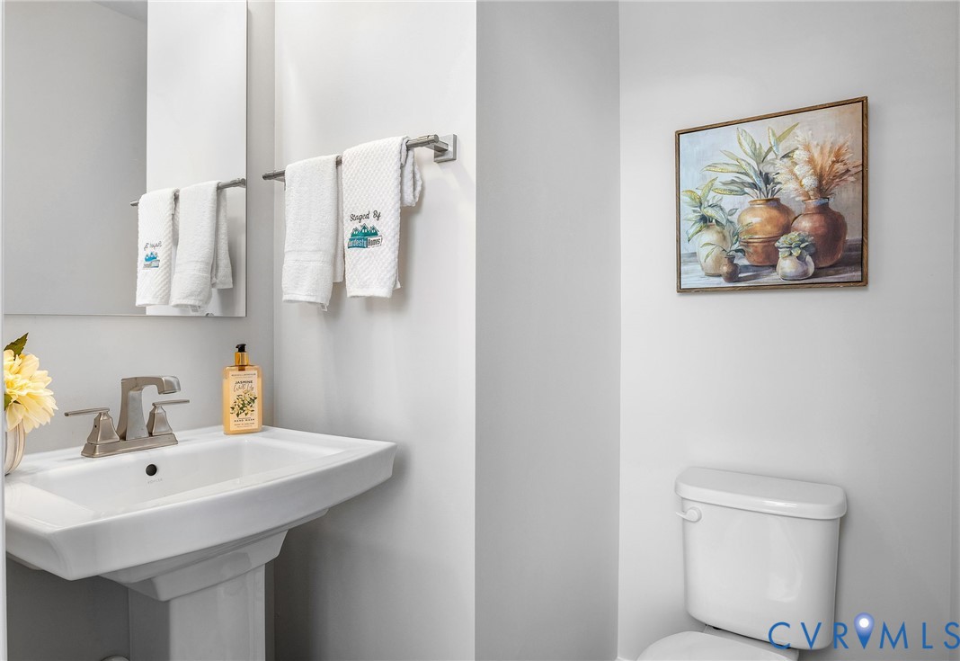 1255 Lazy River Road Midlothian, VA 23114 - Photo 15 of 27 a bathroom with a toilet a sink and mirror