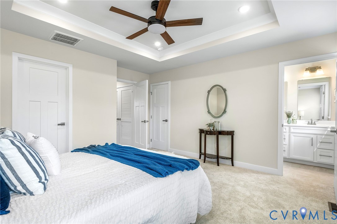 1255 Lazy River Road Midlothian, VA 23114 - Photo 17 of 27 a bedroom with a bed large mirror and furniture