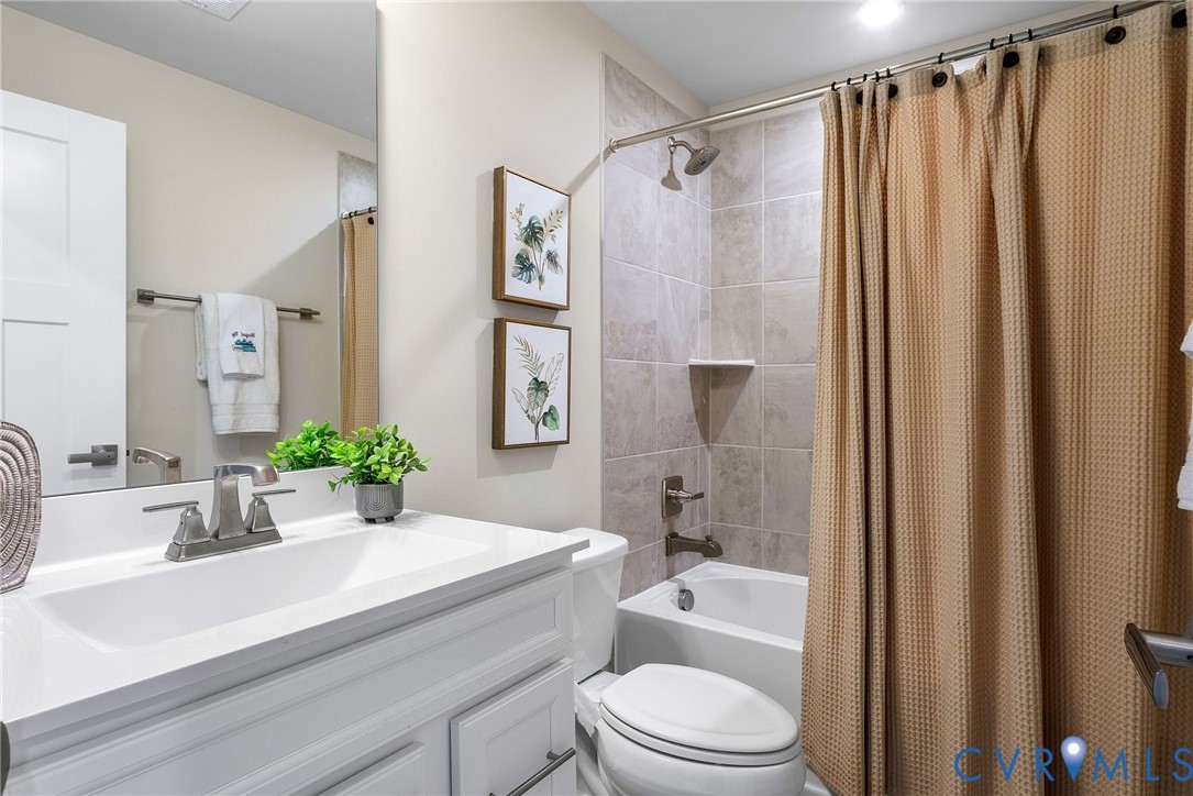 1255 Lazy River Road Midlothian, VA 23114 - Photo 21 of 27 a bathroom with a sink a toilet a mirror and shower
