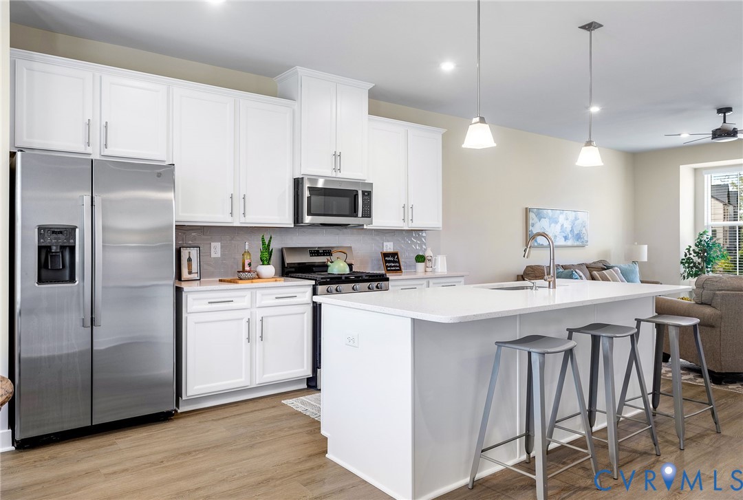 1255 Lazy River Road Midlothian, VA 23114 - Photo 9 of 27 a kitchen with stainless steel appliances a sink a stove a refrigerator and cabinets