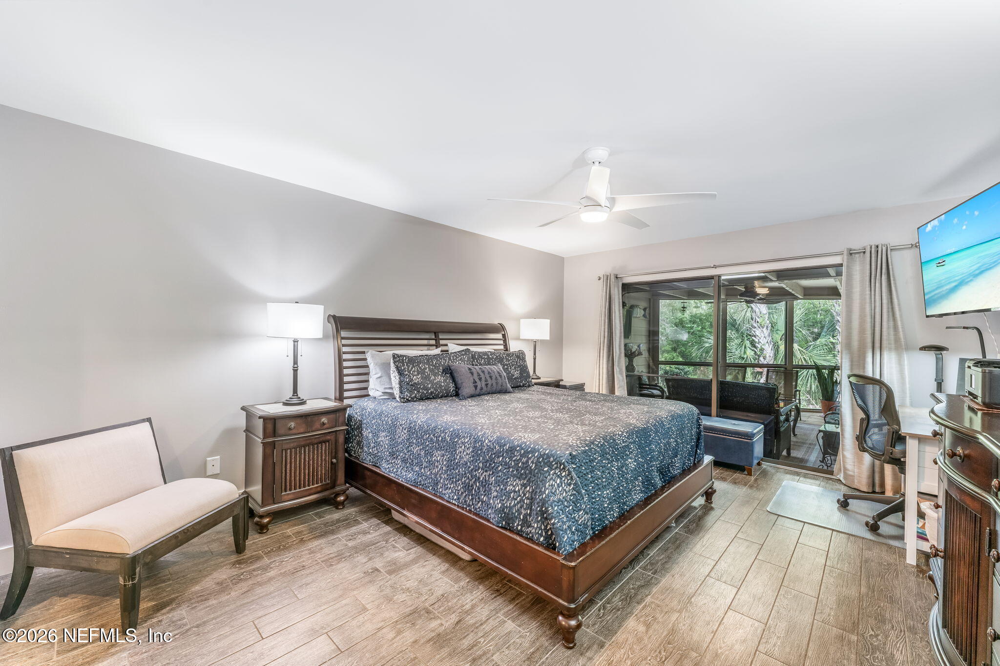 70 Fishermans Cove Road Ponte Vedra Beach, FL 32082 - Photo 23 of 60 a bedroom with a bed a lamp and a large window with wooden floor
