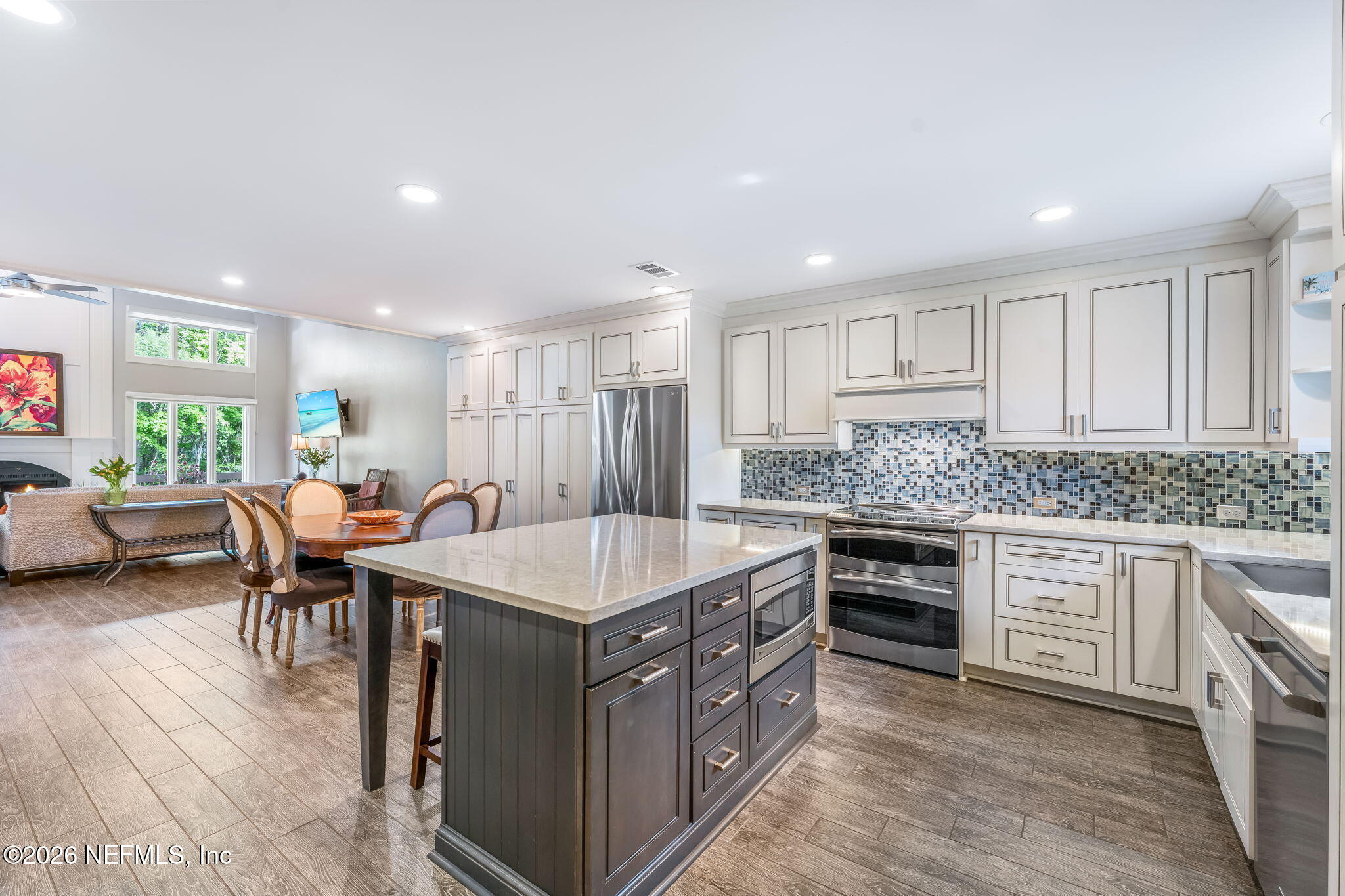 70 Fishermans Cove Road Ponte Vedra Beach, FL 32082 - Photo 7 of 60 a large kitchen with stainless steel appliances a stove a sink a oven a dining table and chairs