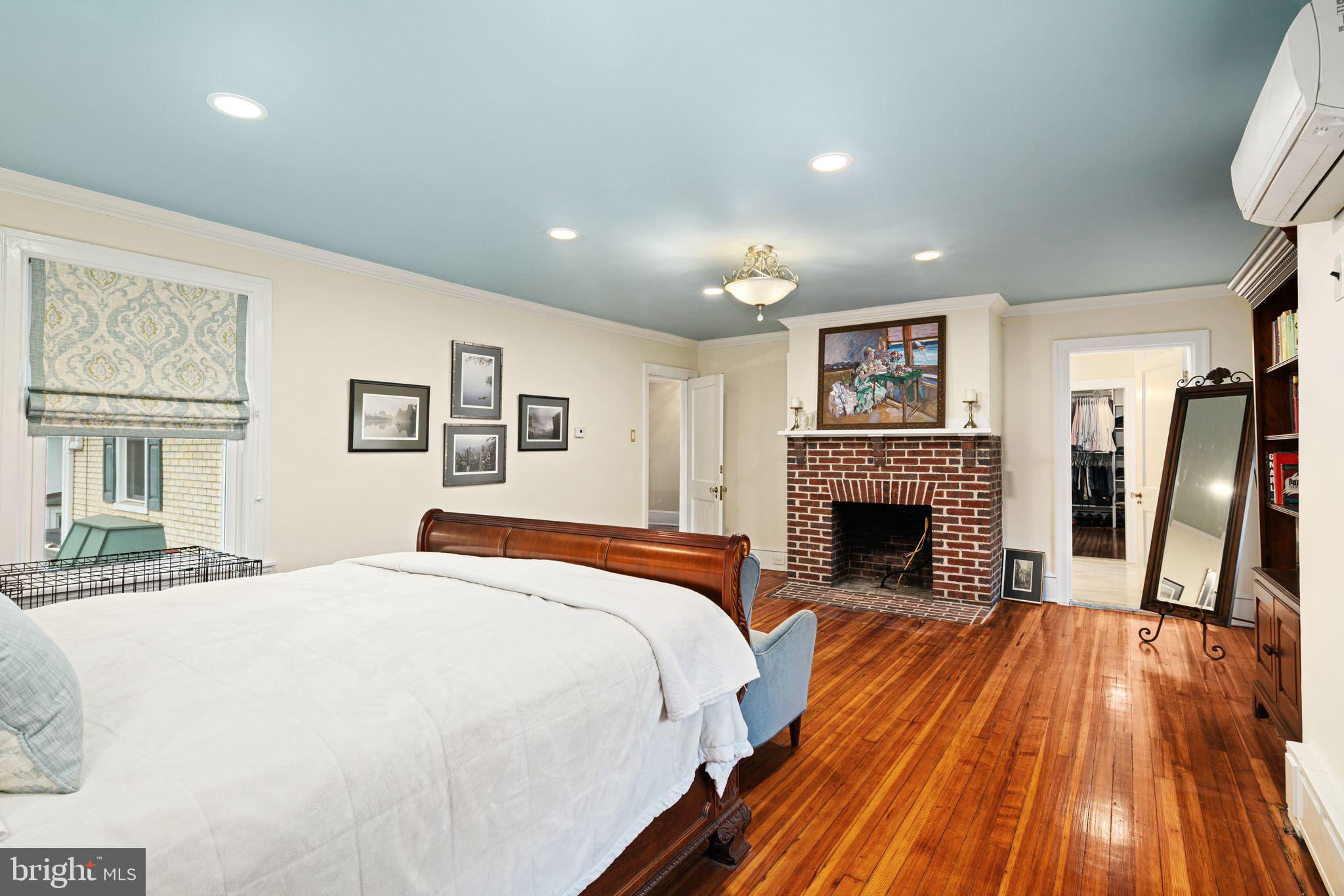 311 Chews Landing Road Haddonfield, NJ 08033 - Photo 20 of 31 a spacious bedroom with a large bed and a fireplace