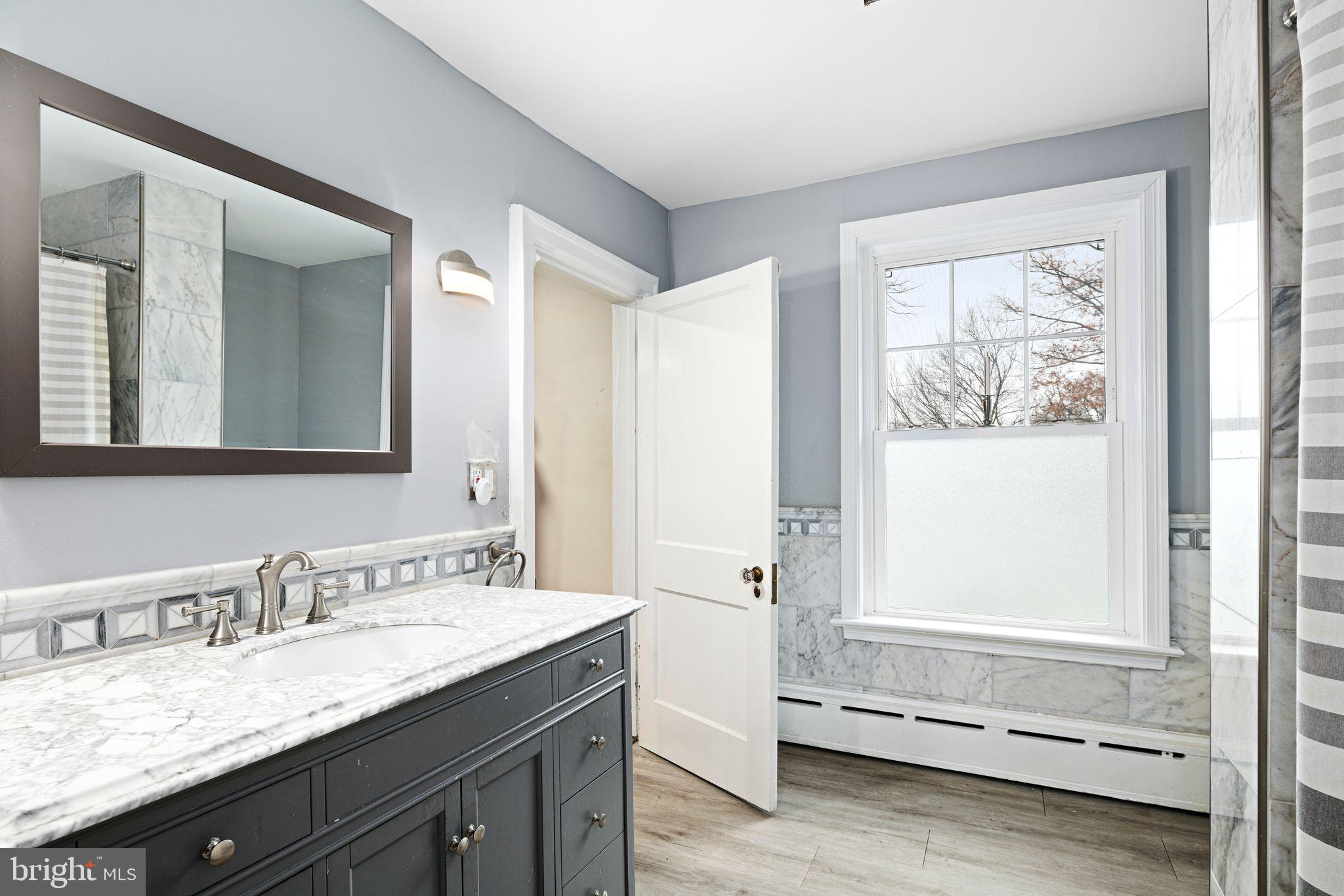 311 Chews Landing Road Haddonfield, NJ 08033 - Photo 25 of 31 a bathroom with a granite countertop sink and a mirror