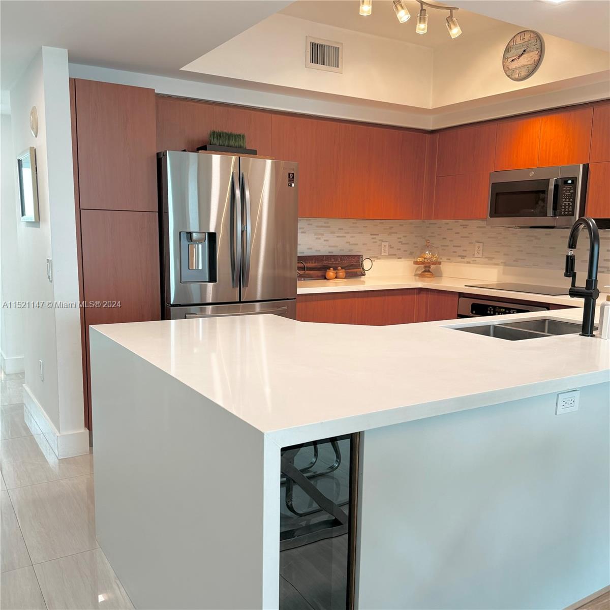 a kitchen with stainless steel appliances a refrigerator and stove