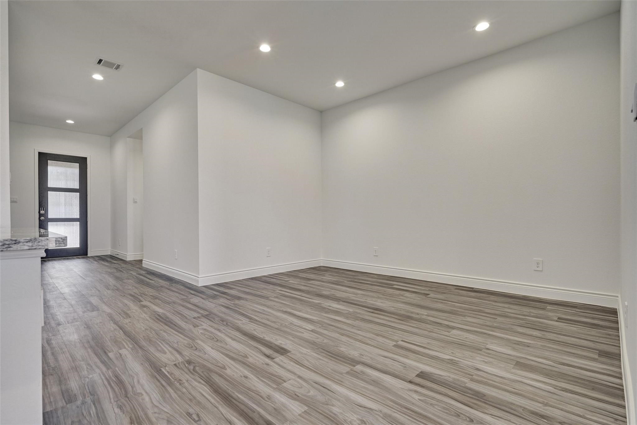 981 Youth Water Road Montgomery, TX 77316 - Photo 14 of 43 an empty room with wooden floor and windows