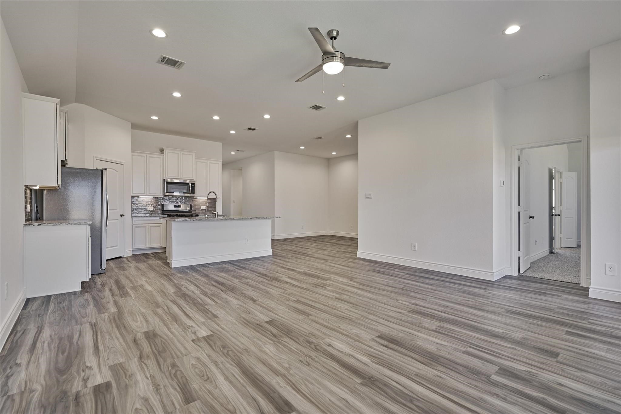 981 Youth Water Road Montgomery, TX 77316 - Photo 23 of 43 a view of kitchen view wooden floors appliances and cabinets