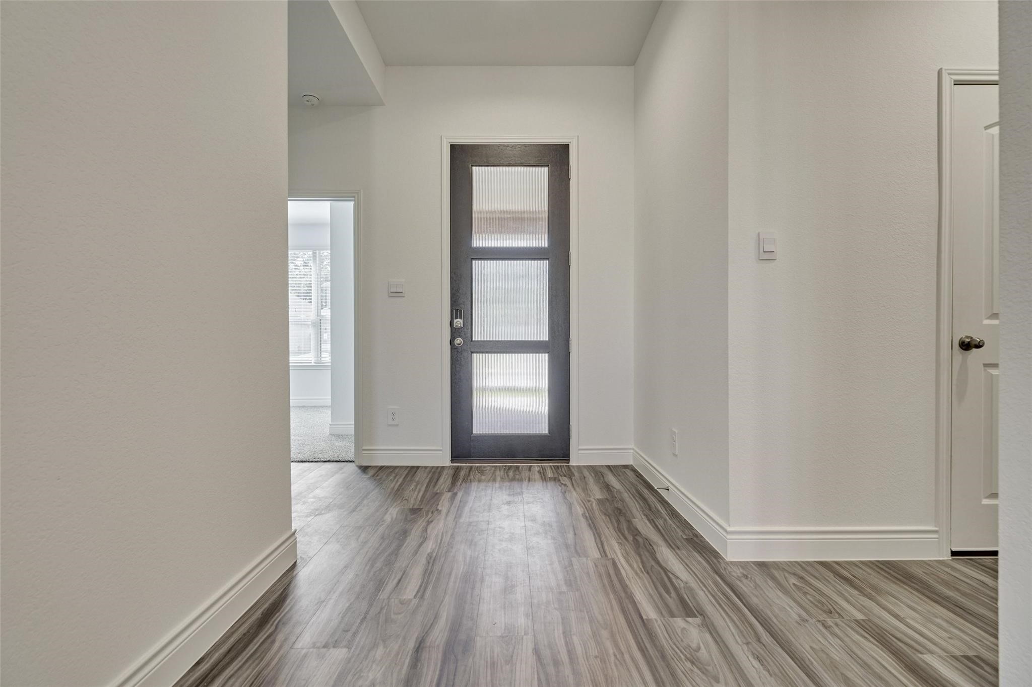 981 Youth Water Road Montgomery, TX 77316 - Photo 3 of 43 wooden floor in an empty room with a window