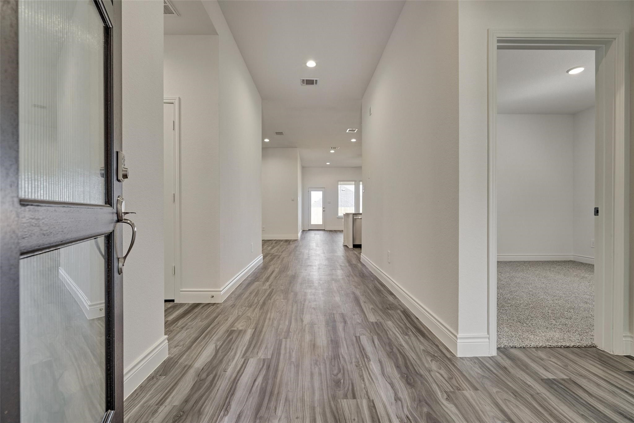 981 Youth Water Road Montgomery, TX 77316 - Photo 4 of 43 a view of a hallway with wooden floor and staircase