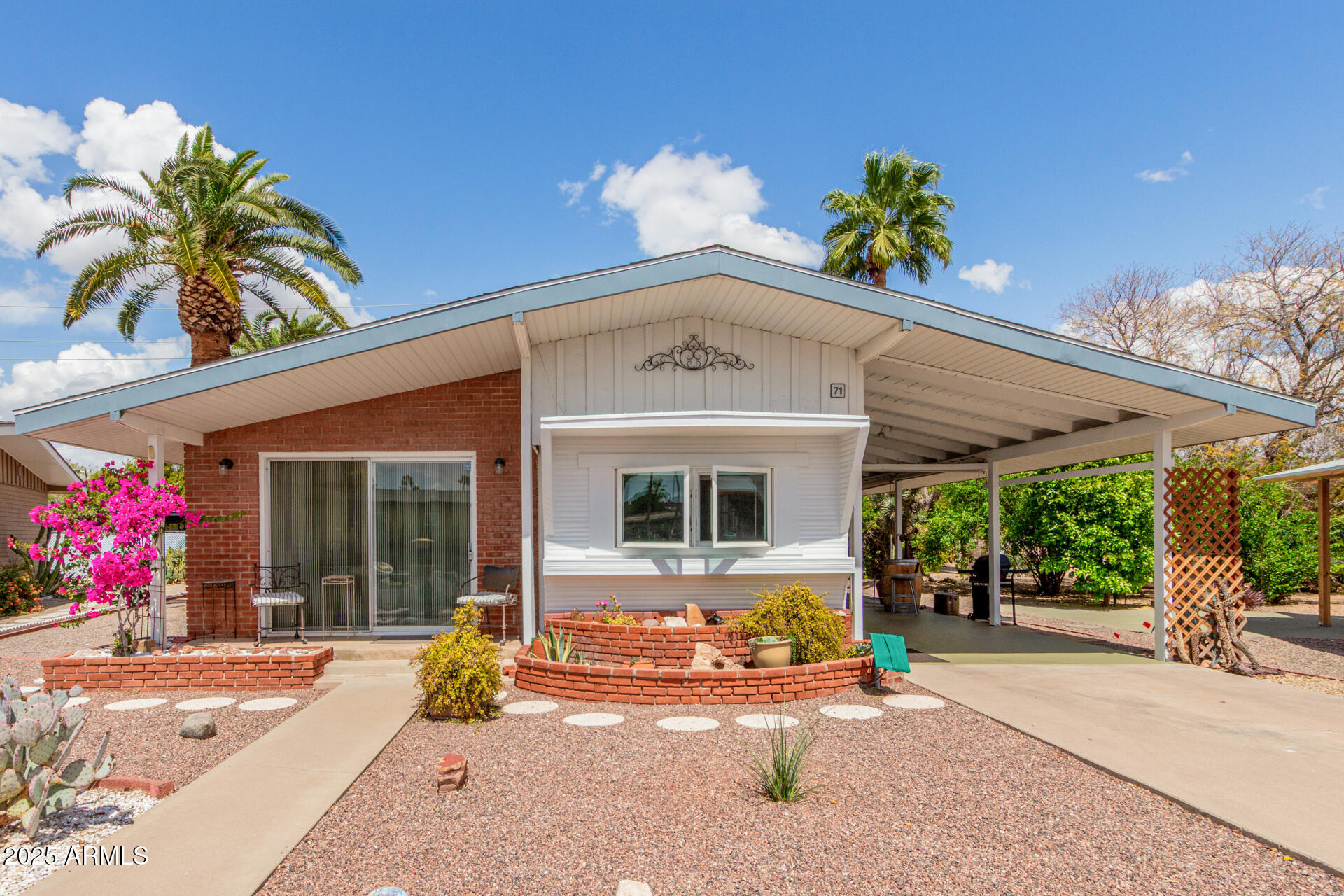 6700 East Thomas Road, Unit 71 Scottsdale, AZ 85251 - Photo 19 of 45 a front view of a house with a yard and potted plants
