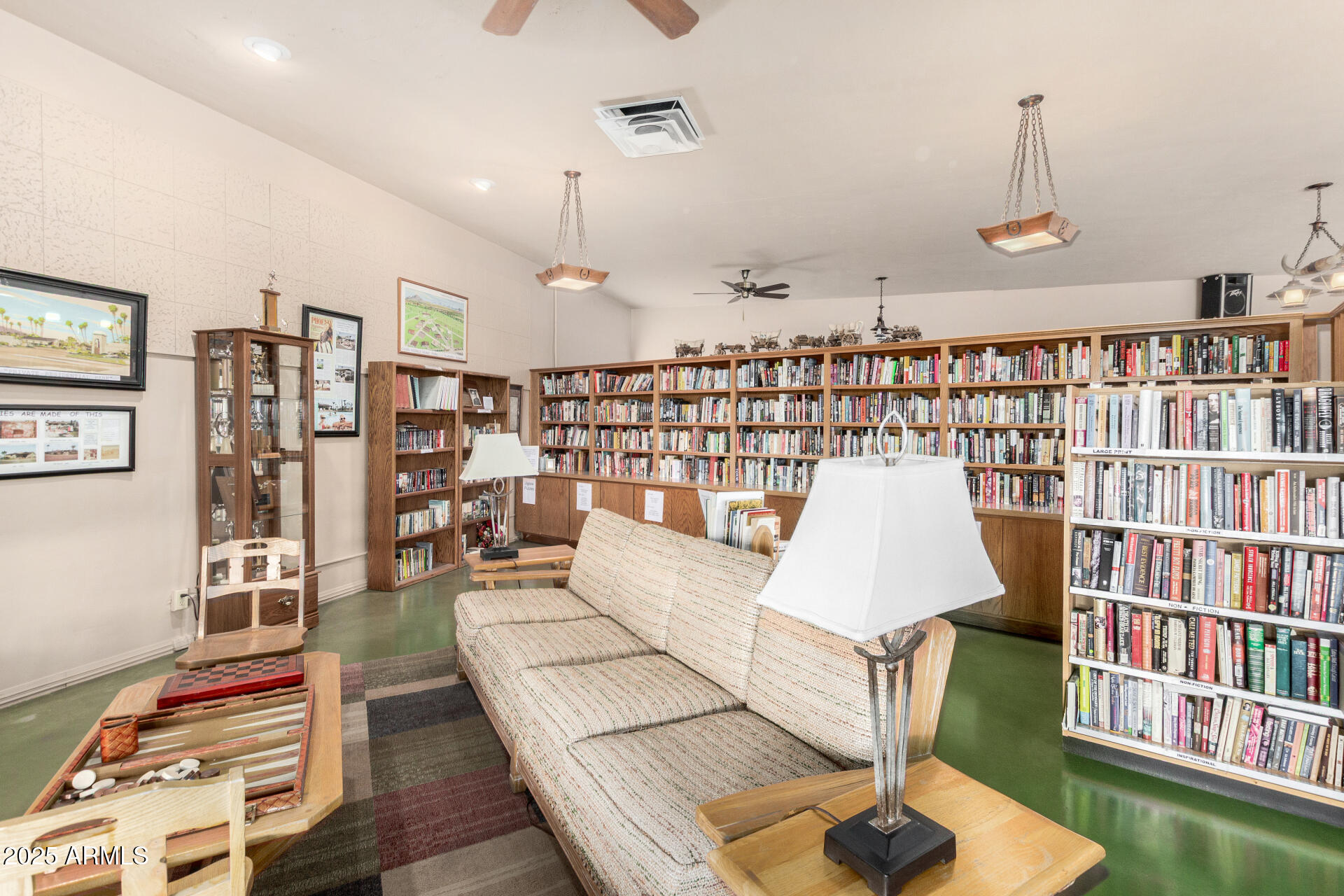 6700 East Thomas Road, Unit 71 Scottsdale, AZ 85251 - Photo 37 of 45 a living room with furniture and a book shelf