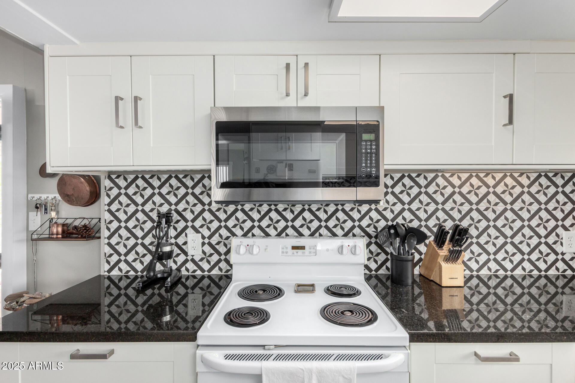 6700 East Thomas Road, Unit 71 Scottsdale, AZ 85251 - Photo 8 of 45 a kitchen with a stove and a microwave