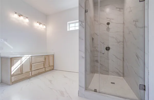 a bathroom with a bathtub and shower
