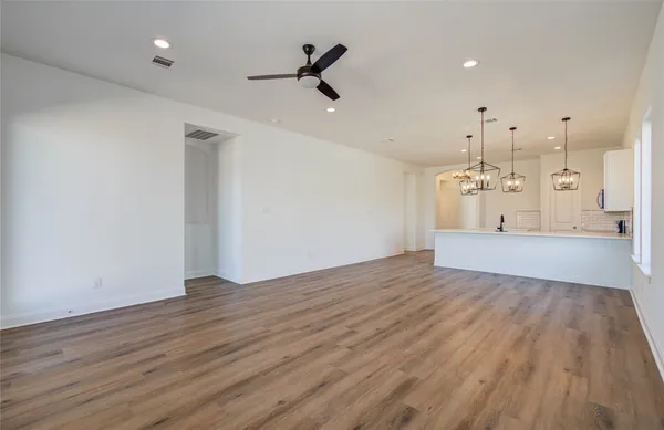 a view of a kitchen with wooden floor and a sink