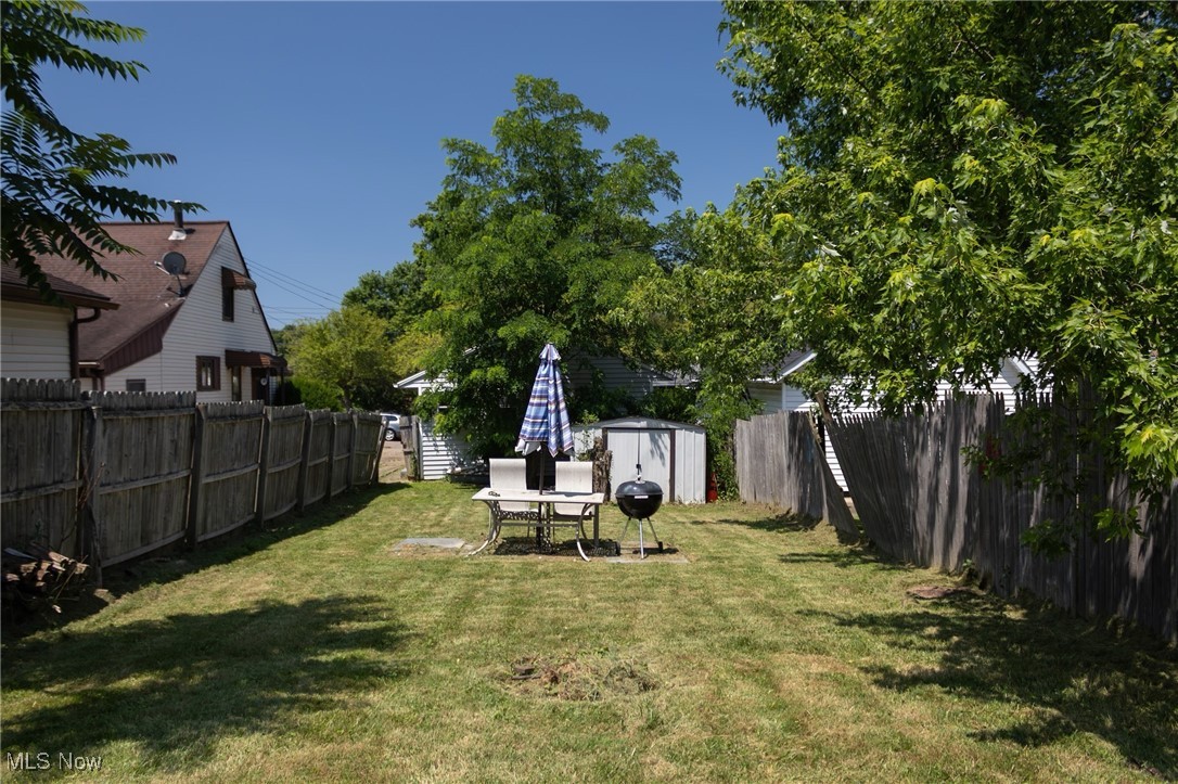 353 Gibbs Road Akron, OH 44312 - Photo 4 of 15 Fenced backyard featuring a storage shed