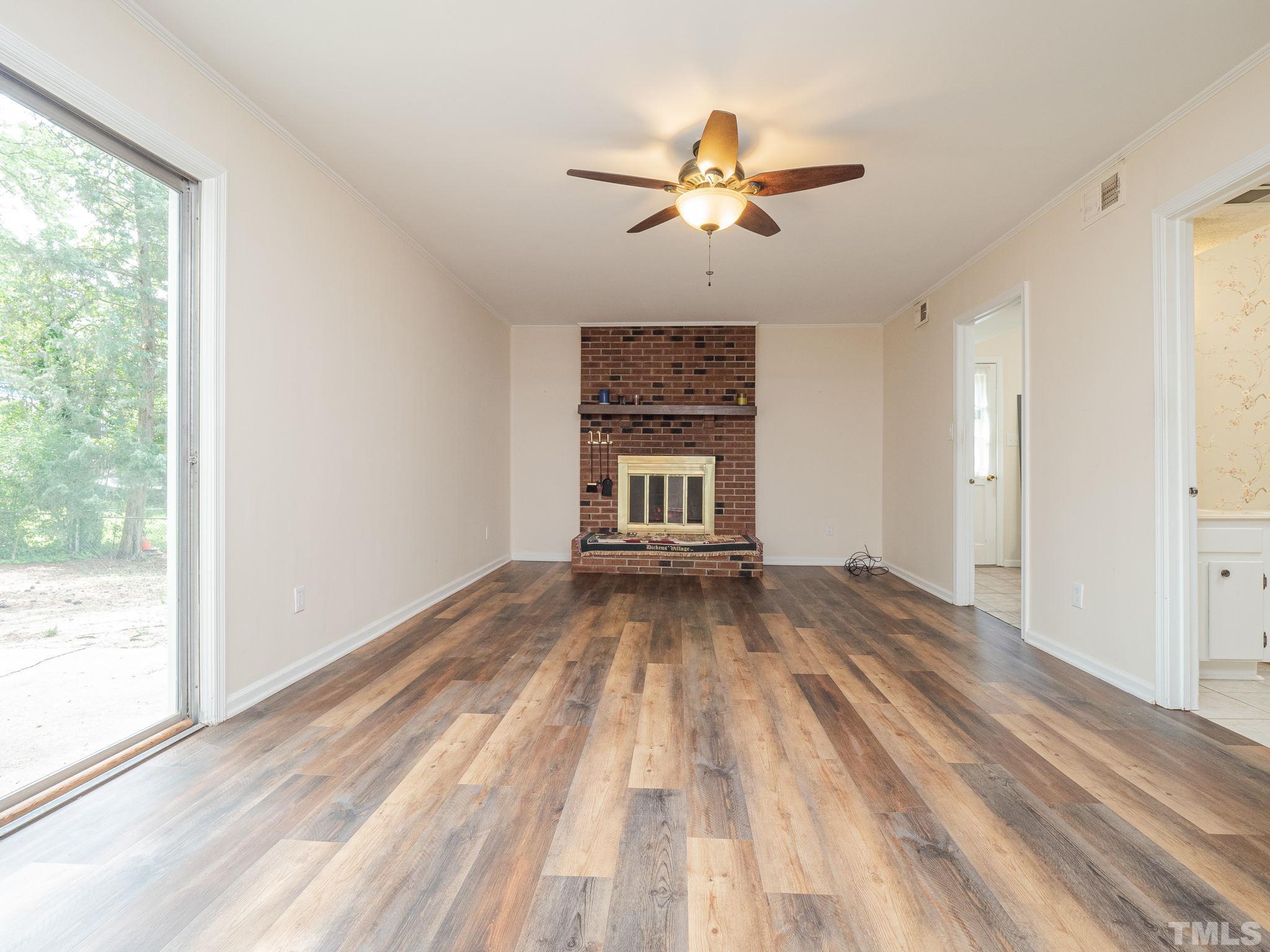 4504 Waterbury Road Raleigh, NC 27604 - Photo 11 of 38 a view of empty room with wooden floor and fan