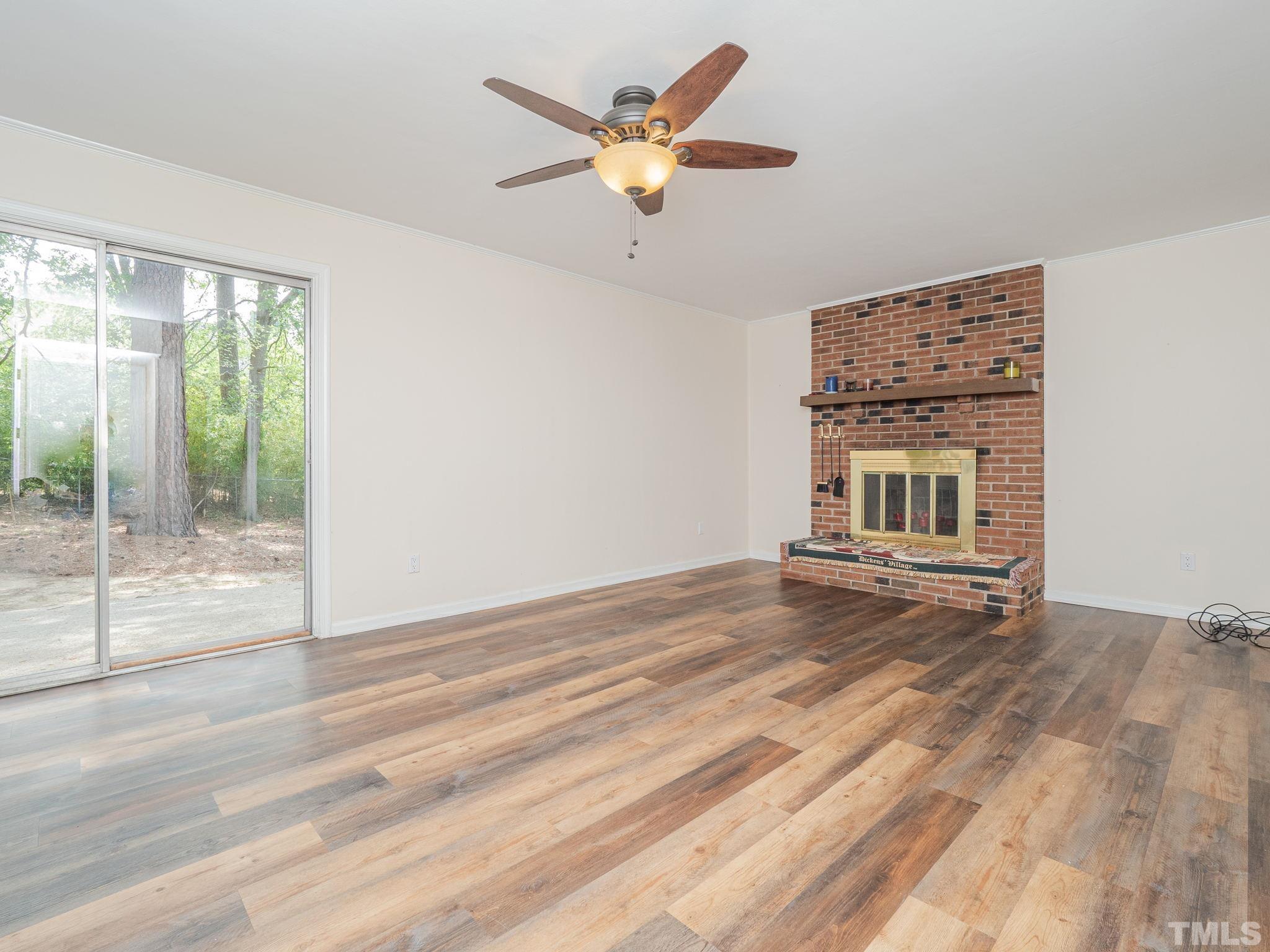 4504 Waterbury Road Raleigh, NC 27604 - Photo 12 of 38 a view of an empty room with a window and a ceiling fan