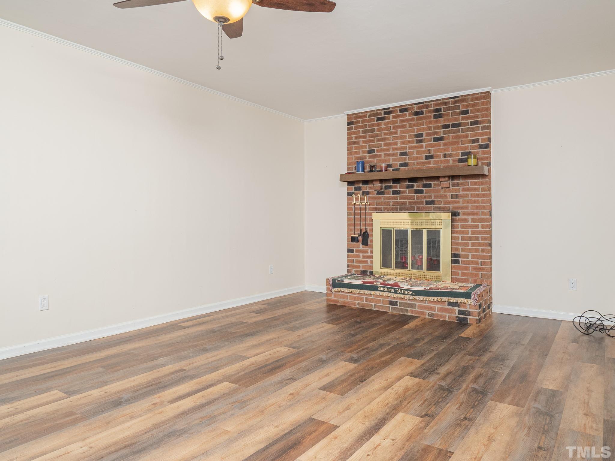 4504 Waterbury Road Raleigh, NC 27604 - Photo 13 of 38 a view of an empty room with window and wooden floor