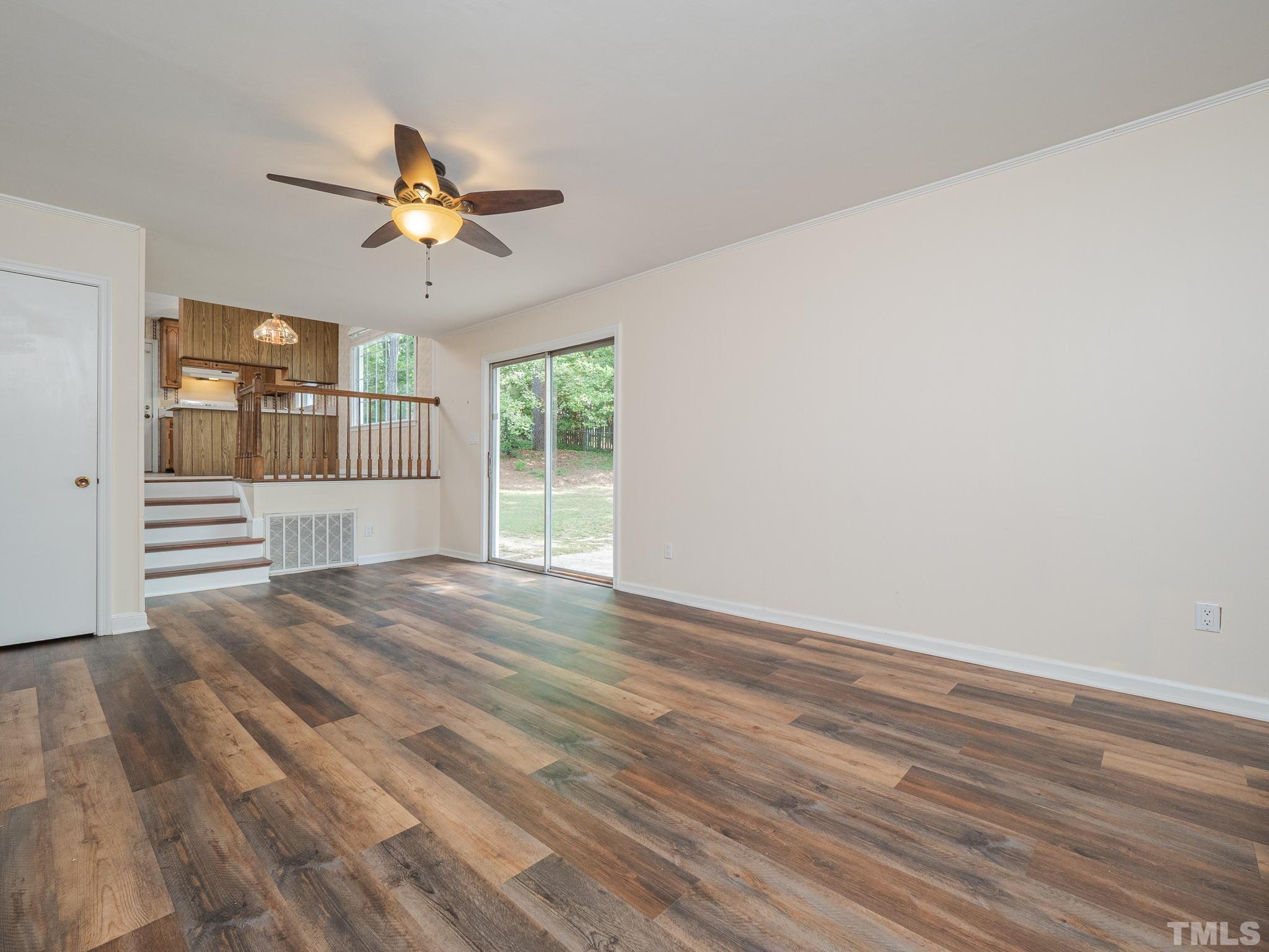 4504 Waterbury Road Raleigh, NC 27604 - Photo 14 of 38 a view of empty room with wooden floor and fan