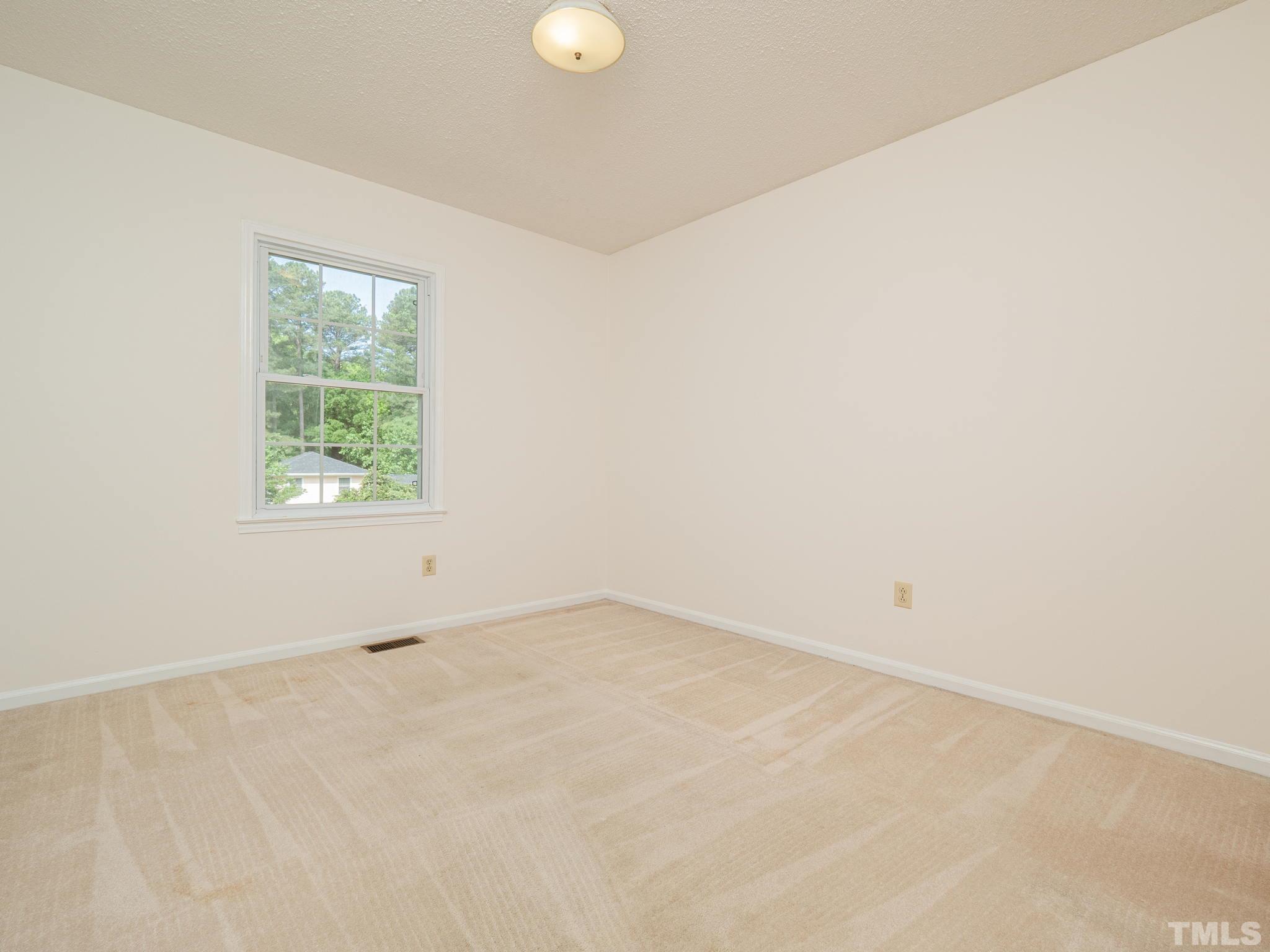 4504 Waterbury Road Raleigh, NC 27604 - Photo 18 of 38 an empty room with a window