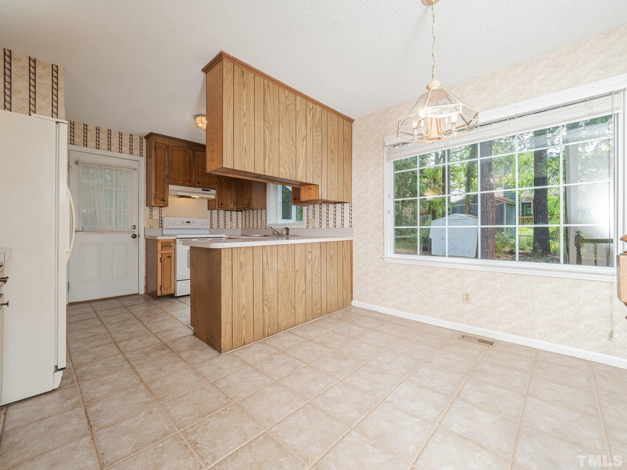 4504 Waterbury Road Raleigh, NC 27604 - Photo 24 of 38 a view of kitchen with stainless steel appliances cabinets and large window