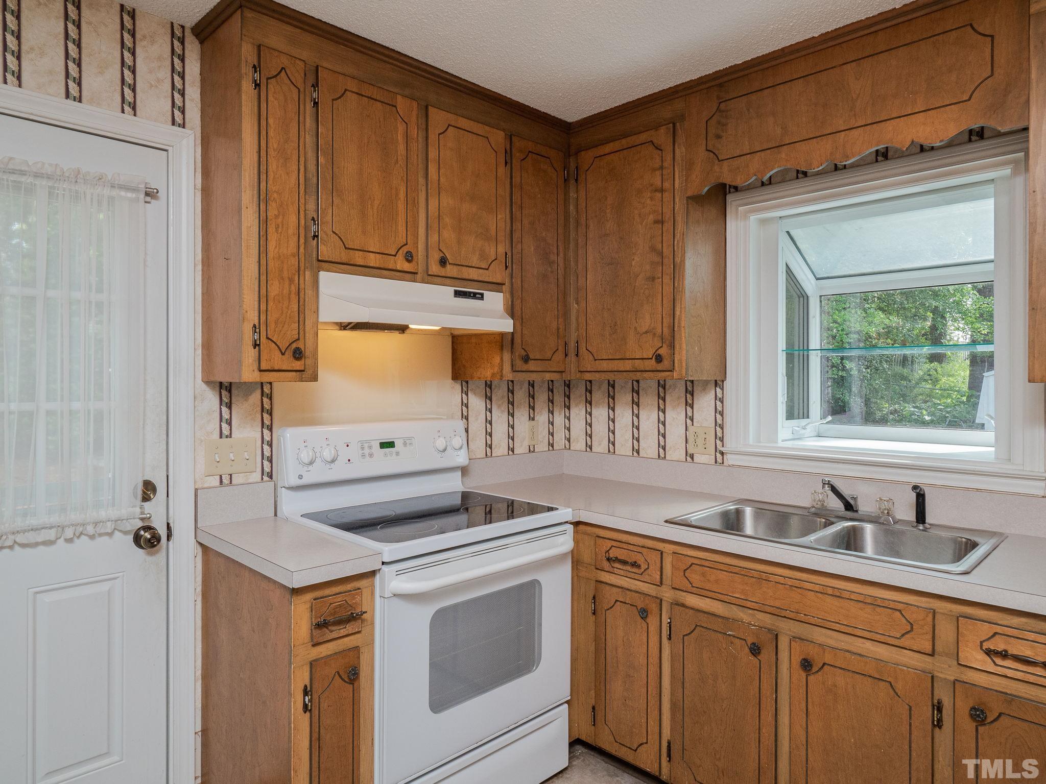 4504 Waterbury Road Raleigh, NC 27604 - Photo 26 of 38 a kitchen with a sink stove and cabinets