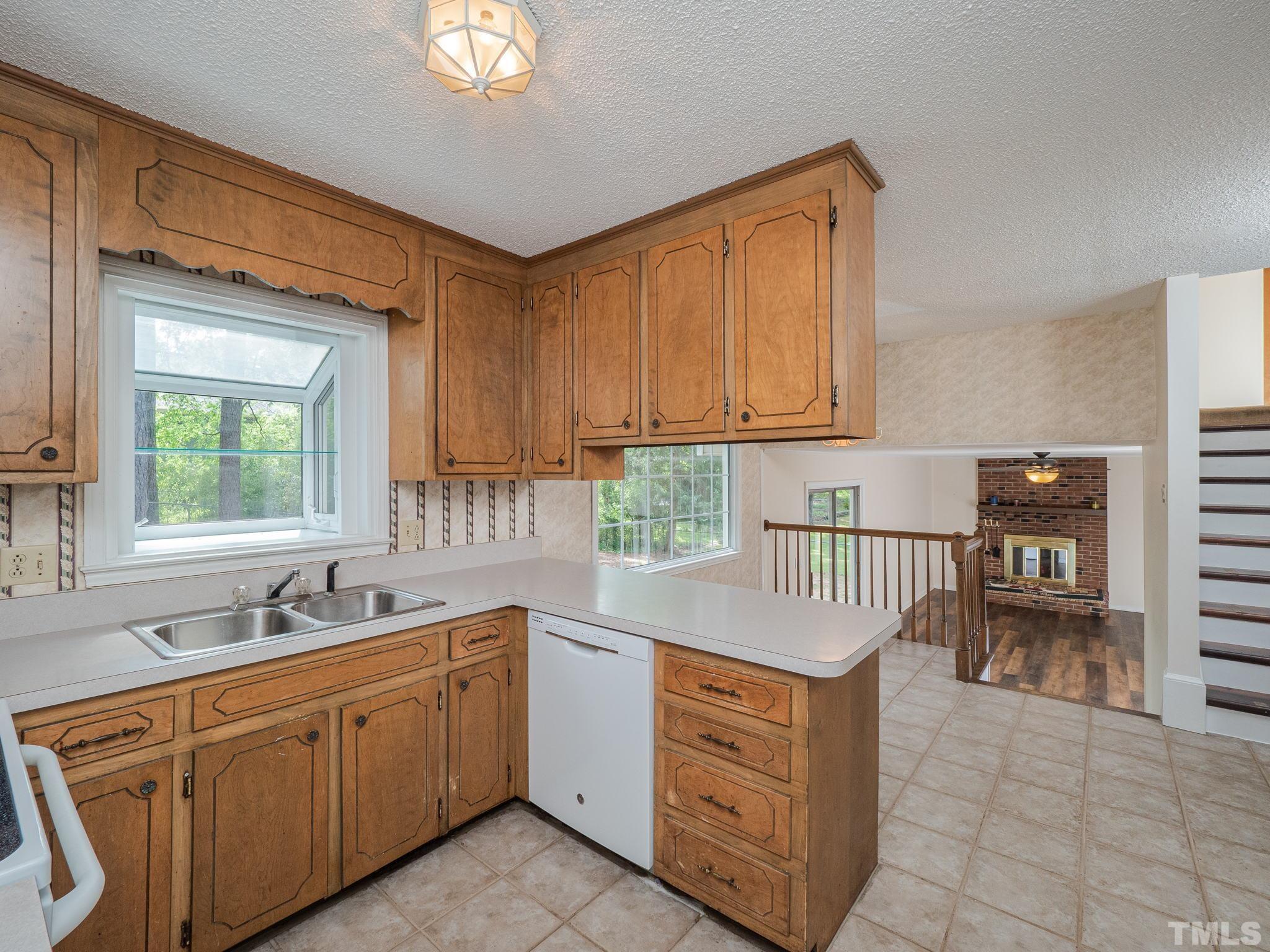 4504 Waterbury Road Raleigh, NC 27604 - Photo 27 of 38 a kitchen with sink cabinets and window