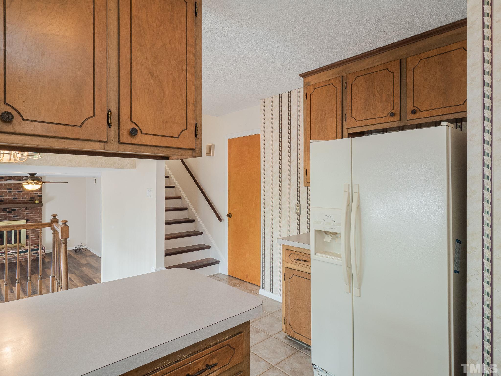 4504 Waterbury Road Raleigh, NC 27604 - Photo 29 of 38 a view of a kitchen with furniture and staircase