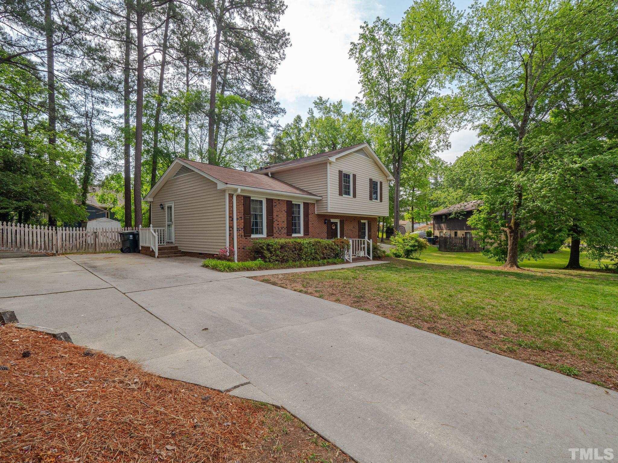 4504 Waterbury Road Raleigh, NC 27604 - Photo 3 of 38 a front view of a house with a yard and trees