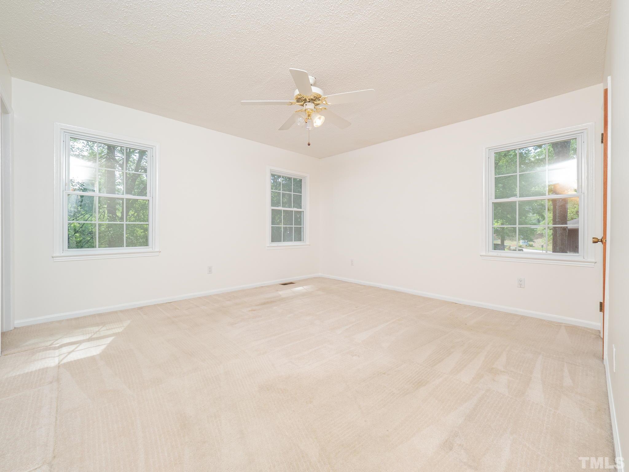 4504 Waterbury Road Raleigh, NC 27604 - Photo 33 of 38 an empty room with a window and a ceiling fan