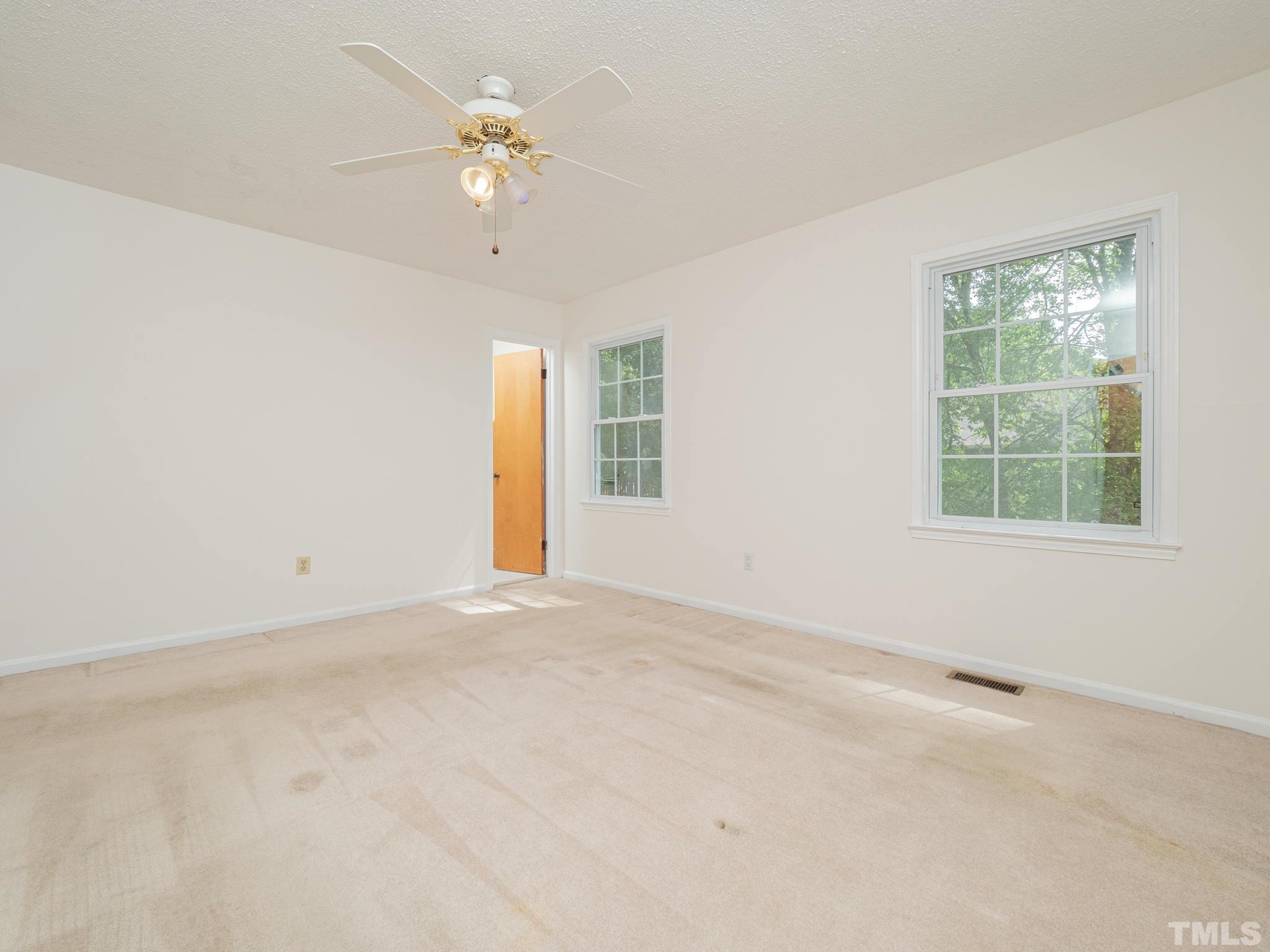 4504 Waterbury Road Raleigh, NC 27604 - Photo 35 of 38 an empty room with a window and a ceiling fan