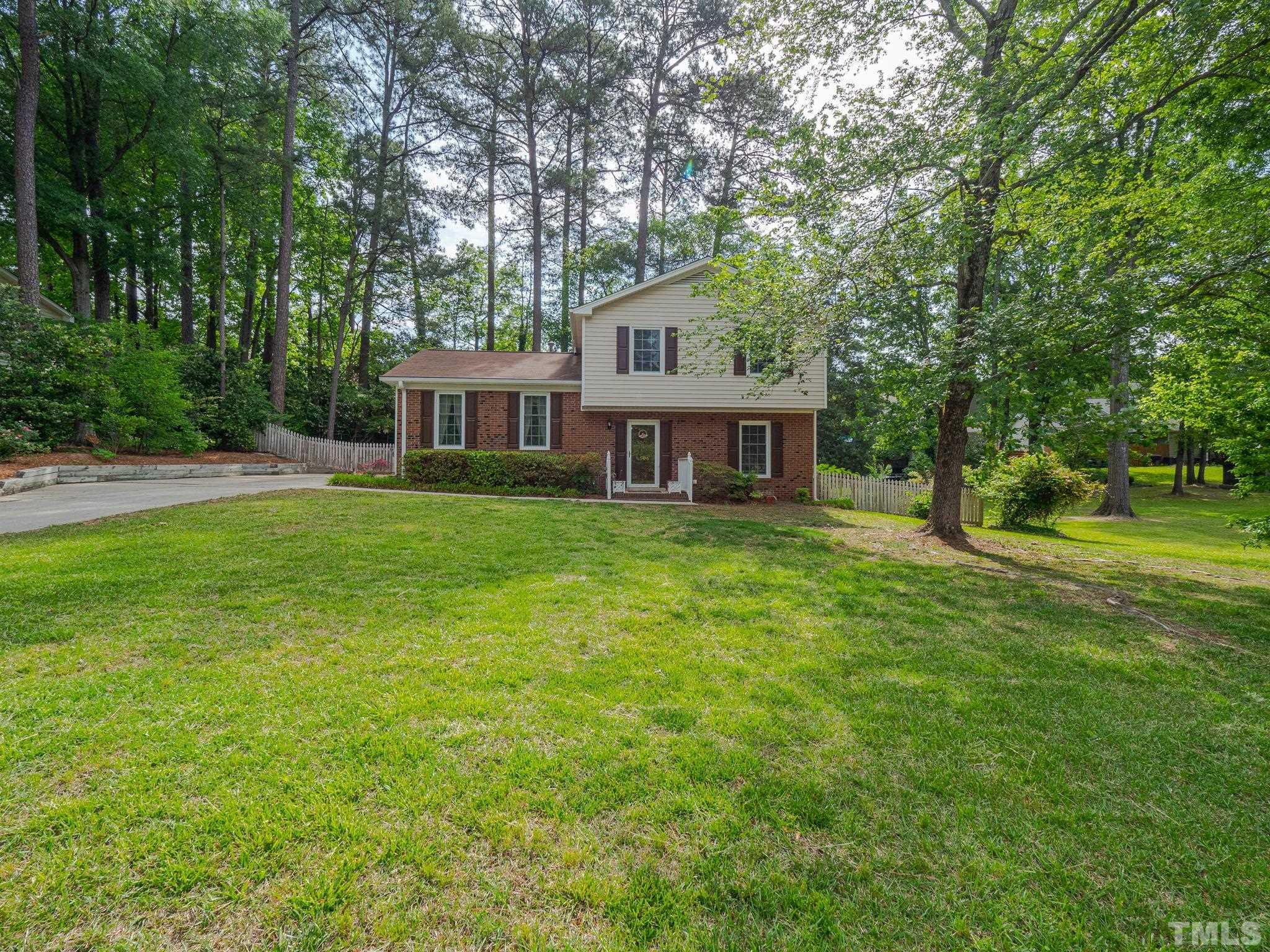 4504 Waterbury Road Raleigh, NC 27604 - Photo 5 of 38 a view of a house with a big yard and large trees