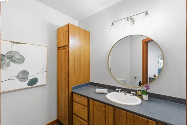 a view of a patio with table and chairs potted plants and large tree