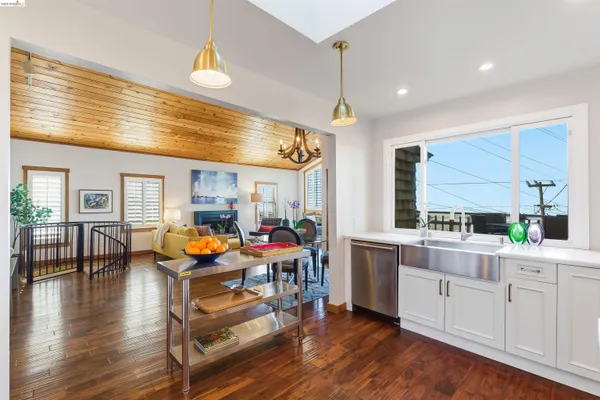 a kitchen with a refrigerator sink and cabinets