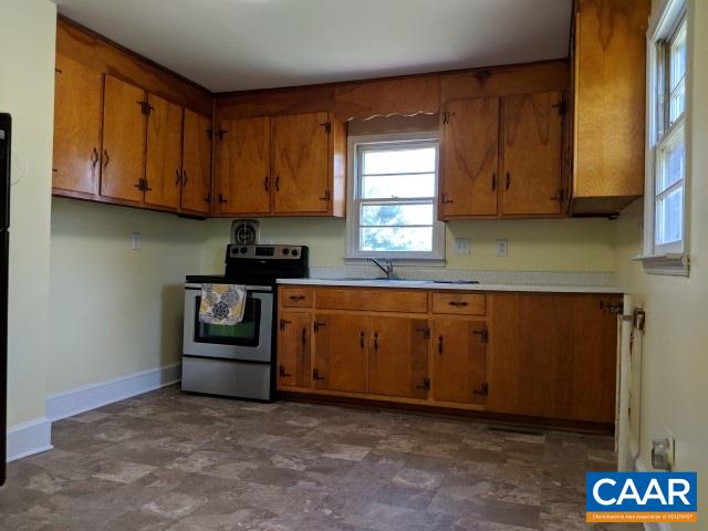 243 Resettlement Road Madison, VA 22727 - Photo 3 of 18 a kitchen with granite countertop a sink cabinets and a window