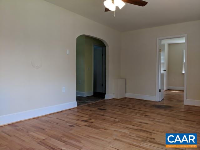 243 Resettlement Road Madison, VA 22727 - Photo 8 of 18 a view of an empty room with wooden floor and a chandelier