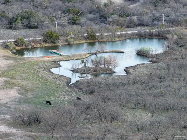a view of a dry yard with wooden fence